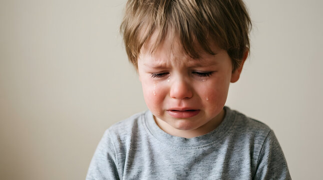 A young boy with tears streaming down his face, his body language conveying a deep sense of sadness and distress, a poignant portrayal of childhood sorrow