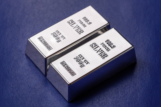 A silver bar, white metal against a backdrop of EU flag, as a concept. A silver bar