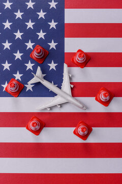 A mock up of airplane with no fly signs on a US flag as a concept for a flight ban