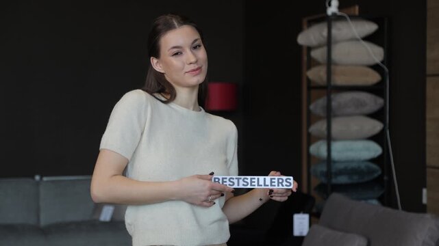 Female shop assistant presenting bestsellers in a furniture store