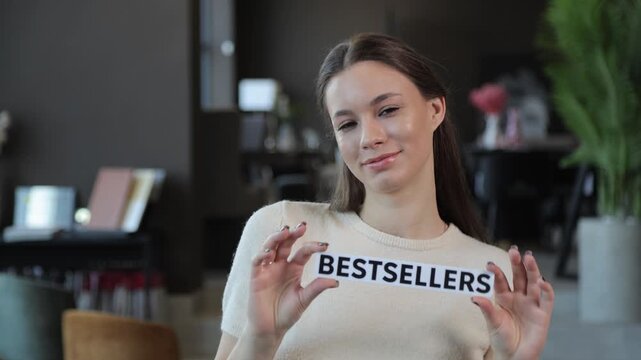 Attractive young woman presenting a bestsellers sign