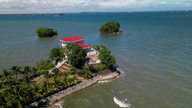 Aerial view of Roca Encantada perched on a coastal islet with surrounding ocean and tropical greenery in Guimaras, Philippines.