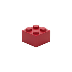 Naklejka premium Single Red Plastic Building Block Toy Brick Isolated on White Background . Red Brick with Eight Studs on white .
