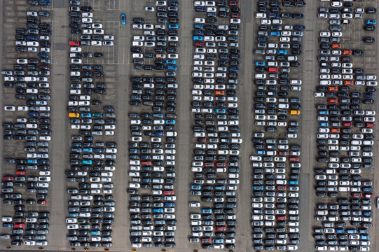 Aerial view of thousands of new cars parked in neat rows at a logistics terminal in the Port of Antwerp, Antwerpen, Vlaanderen, Belgium.
