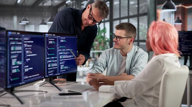 Software Engineer Writes Code On Computer, Collaborating Closely