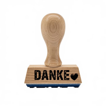 Wooden rubber stamp with the german word danke and a heart symbol isolated on a white background