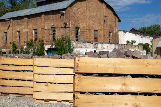 Large wooden crates containing stone paving blocks