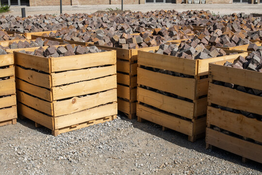 Large wooden crates containing stone paving blocks