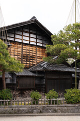 Traditional Japanese wooden architecture featuring dark timber beams and white plaster walls of a historic house in Kanazawa © Anton Duris Photo