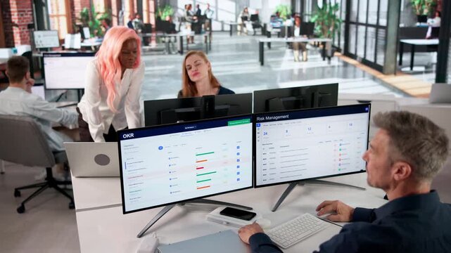 Business Analyst Reviewing OKR Dashboard On Computer