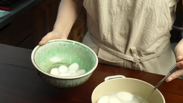 Ladling Korean Rice Cake Soup into Bowl