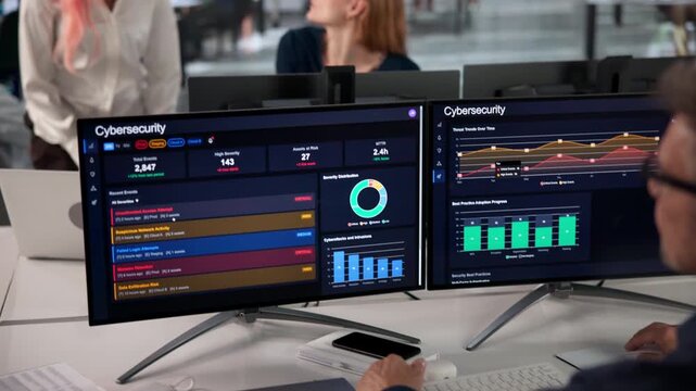 Cybersecurity Engineer Closely Monitors Computer System Dashboard