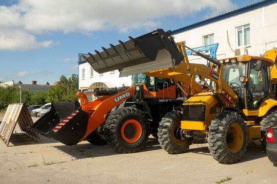 Russia. Samara, August 22, 2024: new construction equipment on the trading platform near the store on a sunny summer day. Text in Russian: gidroremservis