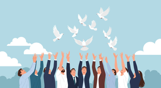 Group of people releasing white doves into a clear blue sky