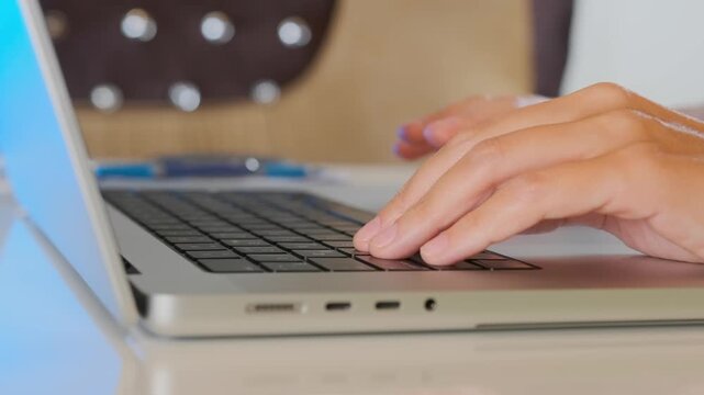 Female hand using laptop touchpad in close-up, navigating interface and browsing online content, cursor control and digital interaction, everyday computer usage and internet activity