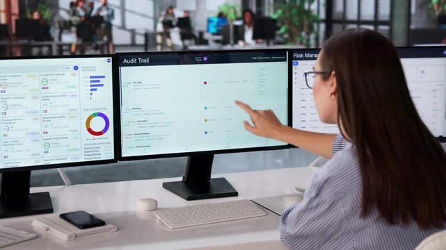 Auditor Reviews Compliance Logs On Multiple Screens