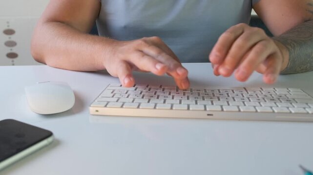 Man using keyboard and mouse at computer desk in front view, switching between typing and cursor control, working on pc, handling digital tasks, office workflow and online activity process
