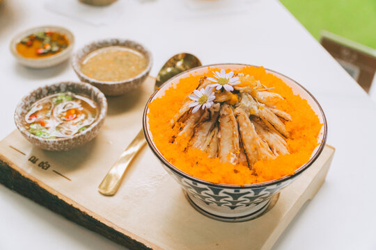 Thai food spread with curry papaya salad and fresh vegetables on table