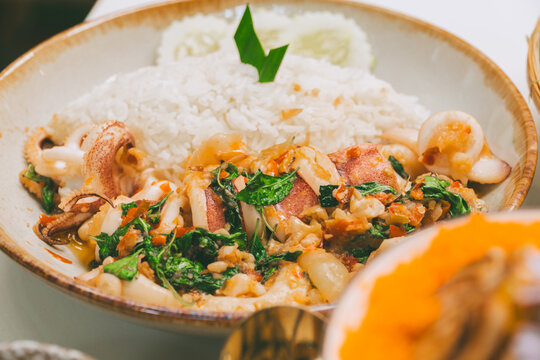 Thai larb spicy minced pork salad with herbs on white plate