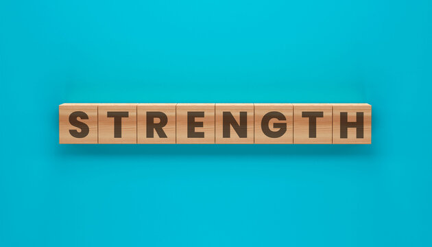 Strength in Block Letters: The word strength, a powerful term, is artfully spelled out using wooden blocks, each letter crisply etched against a bright, uniform backdrop.