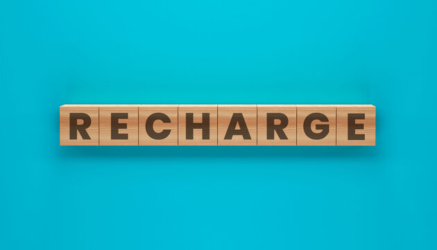 Recharge: A vibrant image of the word Recharge spelled out on wooden blocks, suggesting a sense of renewal and revitalization.