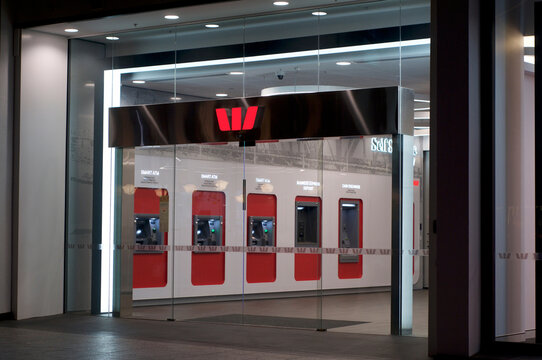 Illuminated Westpac Bank sign and ATM hall