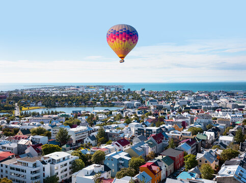 Hot air balloon flying over colorful buildings and Icelandic houses - Reykjavik, Iceland