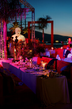 Sunset dining event with theatrical host and ambient neon lighting