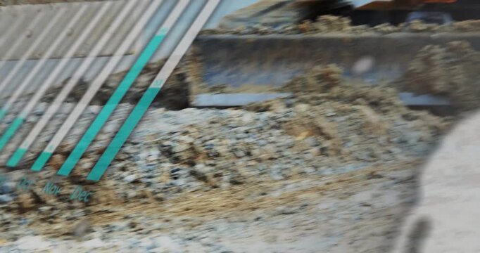 Hydraulics starting excavator bucket scraping and pushing gravel, showing teal overlays for grading