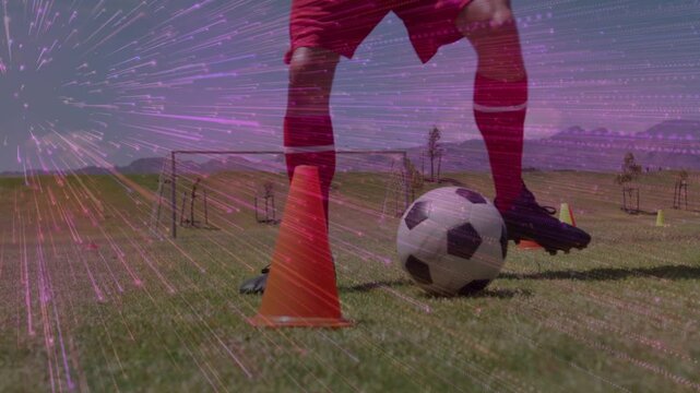 Male player touching ball and dribbling cones for soccer training, purple overlay tracing movement