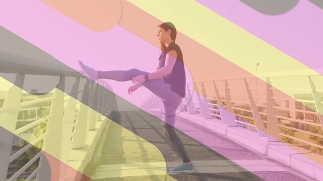 Woman starting pre-run warm-up, lifting leg onto railing and holding hamstring stretch for fitness