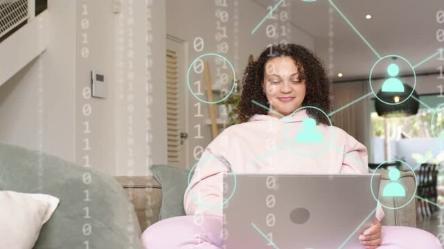 Woman sitting on sofa typing on laptop, causing binary net nodes overlaying torso for remote work