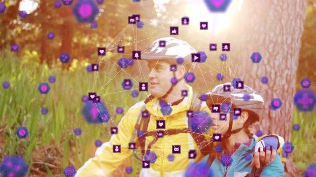 Pair holding bikes while camera revealing purple icons forming into social media sphere for sharing