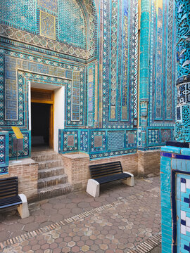 Ornate turquoise tilework facade at Shah-i-Zinda necropolis in Samarkand. Intricate mosaic and majolica patterns decorate the mausoleum entrance. Ideal for travel, heritage, and cultural publications.