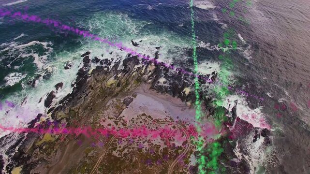 Rocky headland with purple pink green smoke from upper left sweeping dispersing showing wind drift