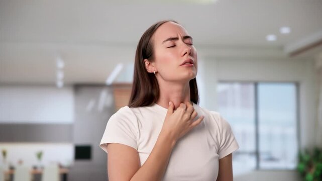 Young Woman Gently Touches Her Neck