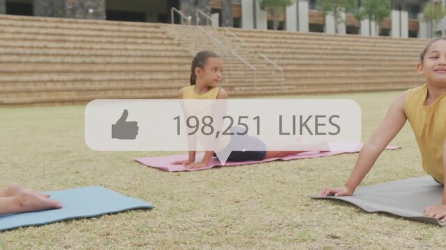 Three girls holding arch on lawn, likes overlay appearing over center and growing for fitness class