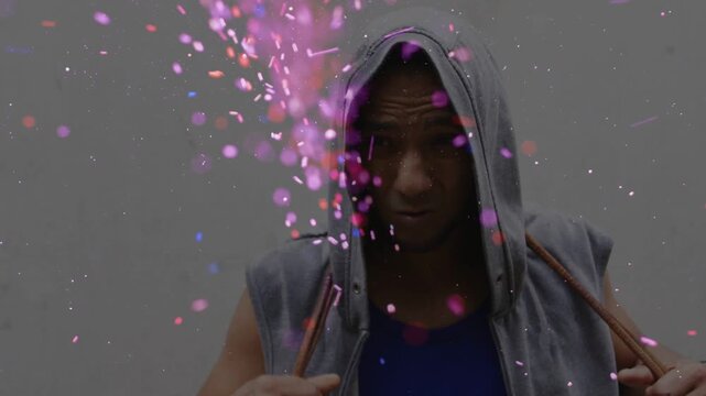 Man pulling cord raising hood in studio sparking magenta burst hiding then revealing face for ads