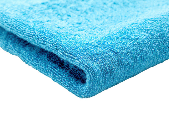 Close up of textured blue fabric isolated on transparent background. Close-up view of the soft texture and vibrant blue color of a folded terry cloth towel isolated on white background.