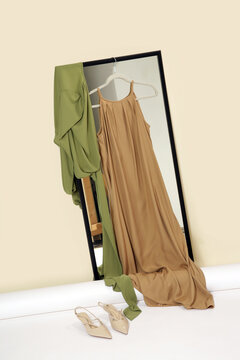 Luxury handmade clothes hanging on the hanger in fashion atelier. Fashion garment displayed on hanger in designer showroom.
