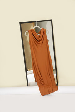Luxury handmade clothes hanging on the hanger in fashion atelier. Fashion garment displayed on hanger in designer showroom.