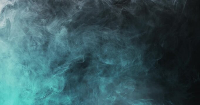 Dark teal smoke moves slowly across a black background forming soft layered textures.