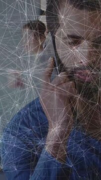 Vertical video: Man taking business call as camera widening and waveform rising around cell