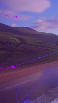Vertical video: Digital pulse sending magenta overlay up, revealing shoreline and hills for detail