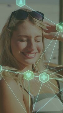 Vertical video: Woman adjusting shades, squinting in sun while health icons overlaying her face