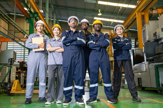 Team of engineers collaborating on industrial solutions in manufacturing plant environment professional teamwork and innovation