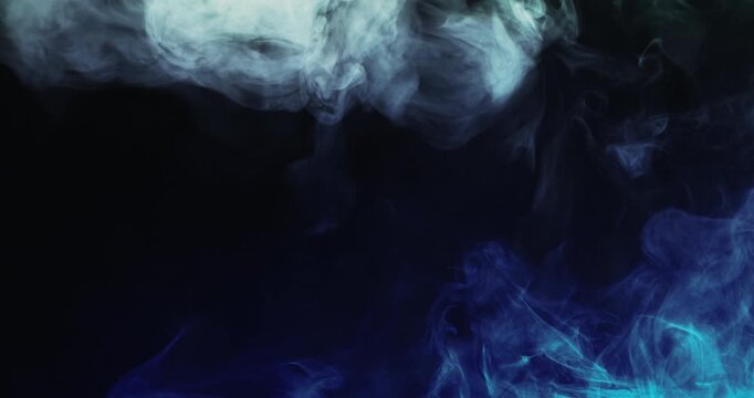 Striking footage of vivid blue and white smoke billowing dramatically against a deep black background, creating a powerful cinematic atmosphere for creative projects.