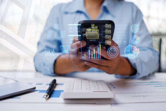 Business professional analyzing financial data and growth charts on a smartphone with digital interface