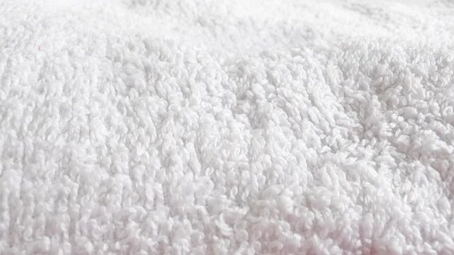 Background of white towels. Detailed shot of the pile of a white towel. white towels for hotels, spa centers, massage rooms, etc. Background with a white towel.