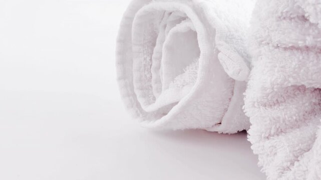 Neatly stacked white linens and towels arranged in tidy piles, perfect for home organization or professional laundry service backgrounds